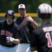 Milan first base coach switches runners during the seventh inning of the game against Richmond on Friday, June 14. Daniel Brenner I AnnArbor.com